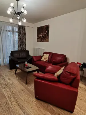 a living room with a red couch and a coffee table at Aurora BW in Belgrade