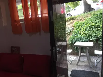 a living room with a red couch and a table at Stadion in Belgrade
