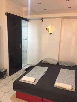 a room with a bed with two towels on it at Stadion in Belgrade