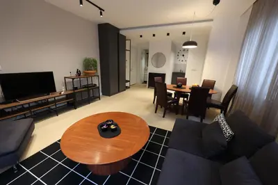 a living room with a couch and a table at Modern apartment in the heart of Belgrade in Belgrade