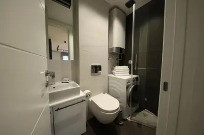 a bathroom with a white toilet and a sink at Modern apartment in the heart of Belgrade in Belgrade
