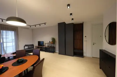 a living room with a table and a dining room at Modern apartment in the heart of Belgrade in Belgrade