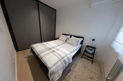 a bedroom with a bed with a black headboard at Modern apartment in the heart of Belgrade in Belgrade