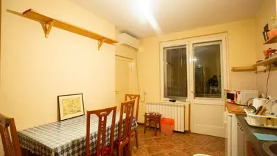 a kitchen with a table and chairs and a window at Private cozy room 1 with shared kitchen in appartment, downtown Belgrade in Belgrade