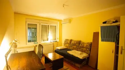 a living room with a couch and a table at Private cozy room 1 with shared kitchen in appartment, downtown Belgrade in Belgrade