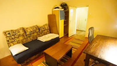 a living room with a couch and a table at Private cozy room 1 with shared kitchen in appartment, downtown Belgrade in Belgrade