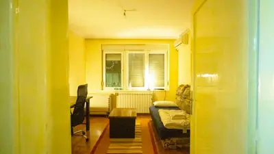 a yellow room with a bed and a window at Private cozy room 1 with shared kitchen in appartment, downtown Belgrade in Belgrade