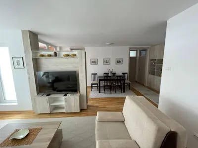 a living room with a couch and a tv at New Belgrade apartment in Belgrade
