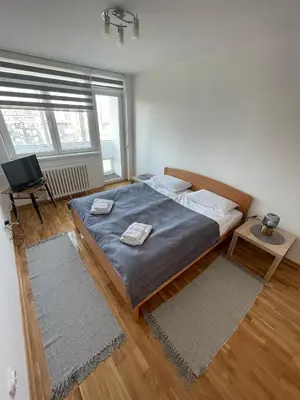 a bedroom with a large bed with two towels on it at New Belgrade apartment in Belgrade