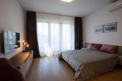 a bedroom with a bed and a large window at Belgrade Center Apartment Lux Residence in Belgrade