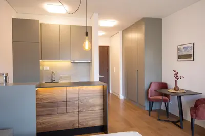 a kitchen with a counter and a table in a room at Belgrade Center Apartment Lux Residence in Belgrade