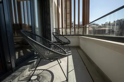 two chairs on a balcony with a view of a city at Belgrade Center Apartment Lux Residence in Belgrade