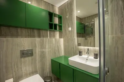 a bathroom with a sink and green cabinets at Belgrade Center Apartment Lux Residence in Belgrade