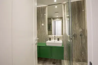 a bathroom with a green sink and a shower at Belgrade Center Apartment Lux Residence in Belgrade