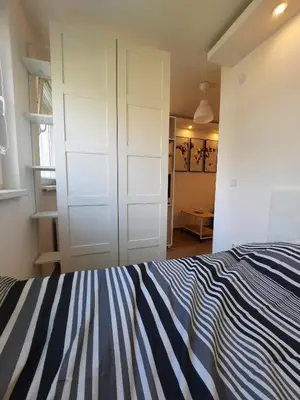 a bedroom with a blue and white striped bed at Apartment Piccolo Ada in Belgrade