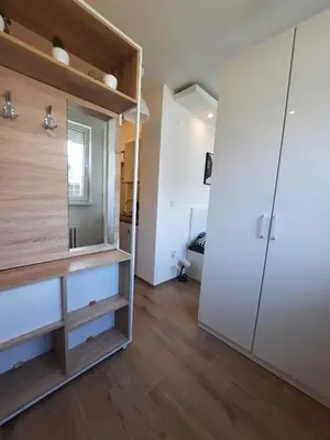 a room with a large white closet and wooden floors at Apartment Piccolo Ada in Belgrade