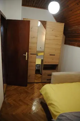 a room with two beds and a mirror at Vikend-kuca Vevericji Kraj in Vranić