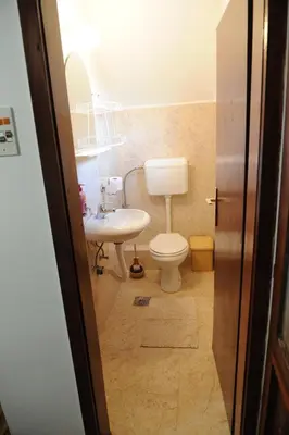 a bathroom with a toilet and a sink at Vikend-kuca Vevericji Kraj in Vranić
