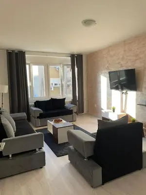 a living room with couches and a flat screen tv at Apartment 51 - Bright, spacious, lux 1 bedroom in the city center - Stari grad in Belgrade