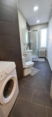 a bathroom with a washing machine in a room at Apartment 51 - Bright, spacious, lux 1 bedroom in the city center - Stari grad in Belgrade