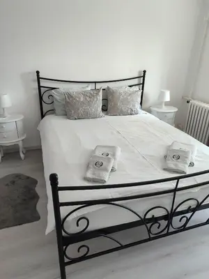 a bedroom with a bed with two pillows on it at Apartment 51 - Bright, spacious, lux 1 bedroom in the city center - Stari grad in Belgrade