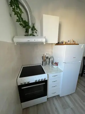 a kitchen with a stove and a white refrigerator at Apartment 51 - Bright, spacious, lux 1 bedroom in the city center - Stari grad in Belgrade