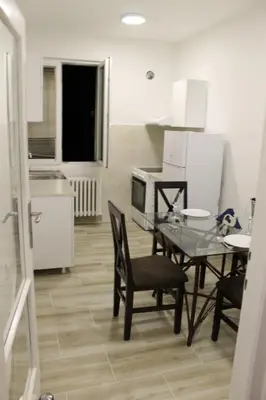 a dining room with a table and chairs and a kitchen at Apartment 51 - Bright, spacious, lux 1 bedroom in the city center - Stari grad in Belgrade