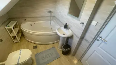 a bathroom with a toilet and a sink and a tub at Charlie&Blueberries 1 in Belgrade