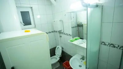 a bathroom with a toilet and a sink and a mirror at Private cozy room 2 with shared kitchen in appartment in Belgrade