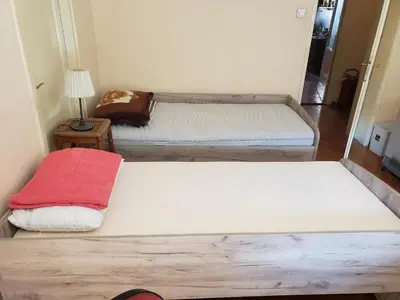 two beds in a small room with a lamp at Private cozy room 2 with shared kitchen in appartment in Belgrade