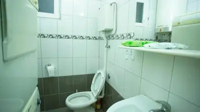 a bathroom with a toilet and a sink at Private cozy room 2 with shared kitchen in appartment in Belgrade
