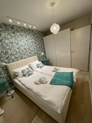 a bedroom with a large white bed with towels on it at Apartment Belgrade Nº3 in Belgrade