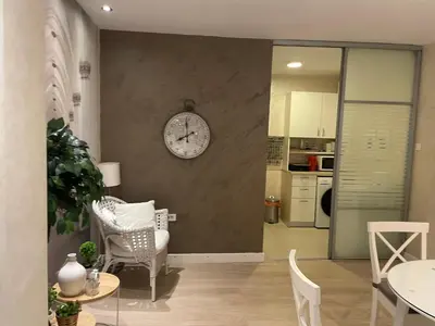 a living room with a clock on the wall at Apartment Belgrade Nº3 in Belgrade