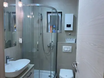 a bathroom with a shower and a toilet and a sink at Apartment Belgrade Nº3 in Belgrade