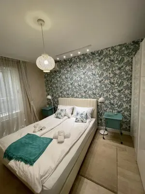 a bedroom with a large bed and a chandelier at Apartment Belgrade Nº3 in Belgrade