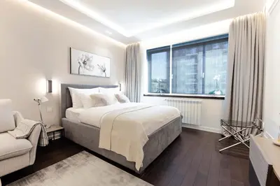 a bedroom with a bed and a window and a couch at A Blok Top Living in Belgrade
