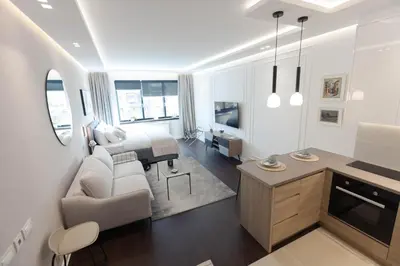 a living room with a couch and a table in a room at A Blok Top Living in Belgrade