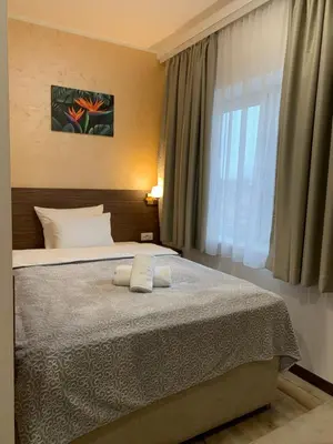 a bedroom with a bed with two pillows and a window at VILA MB in Ruma