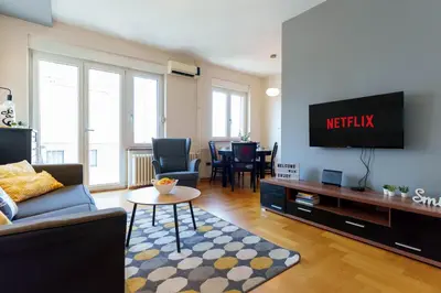 a living room with a couch and a flat screen tv at Quince Apartment-City Center-Free parking in Belgrade