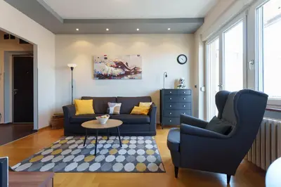a living room with a couch and a table at Quince Apartment-City Center-Free parking in Belgrade