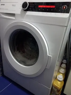 a washing machine with its door open in a room at Sara Apartment in Surčin