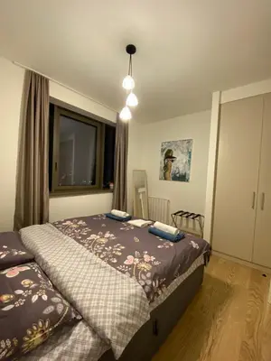 a bedroom with two beds and a window at Aurora 21 in Belgrade