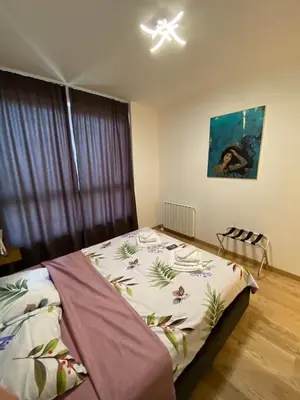a bedroom with a bed with a bedspread with flowers at Aurora 21 in Belgrade
