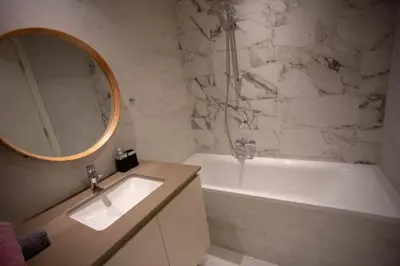 a bathroom with a sink and a tub and a mirror at Aurora 21 in Belgrade