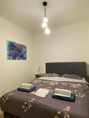a bedroom with a bed with two towels on it at Aurora 21 in Belgrade