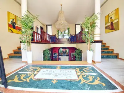 a lobby with a sign on the floor at Red Clay Apartments City Club in Belgrade