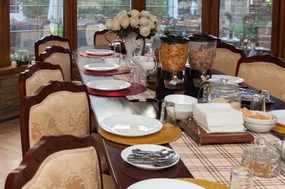 a long table with plates and dishes on it at Red Clay Apartments City Club in Belgrade