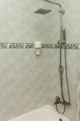 a bathroom with a shower with a tub and a sink at Red Clay Apartments City Club in Belgrade