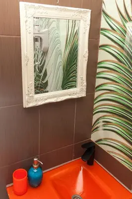 a bathroom with an orange sink and a mirror at Red Clay Apartments City Club in Belgrade