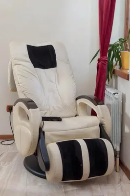 a white reclining chair sitting in a room at Red Clay Apartments City Club in Belgrade